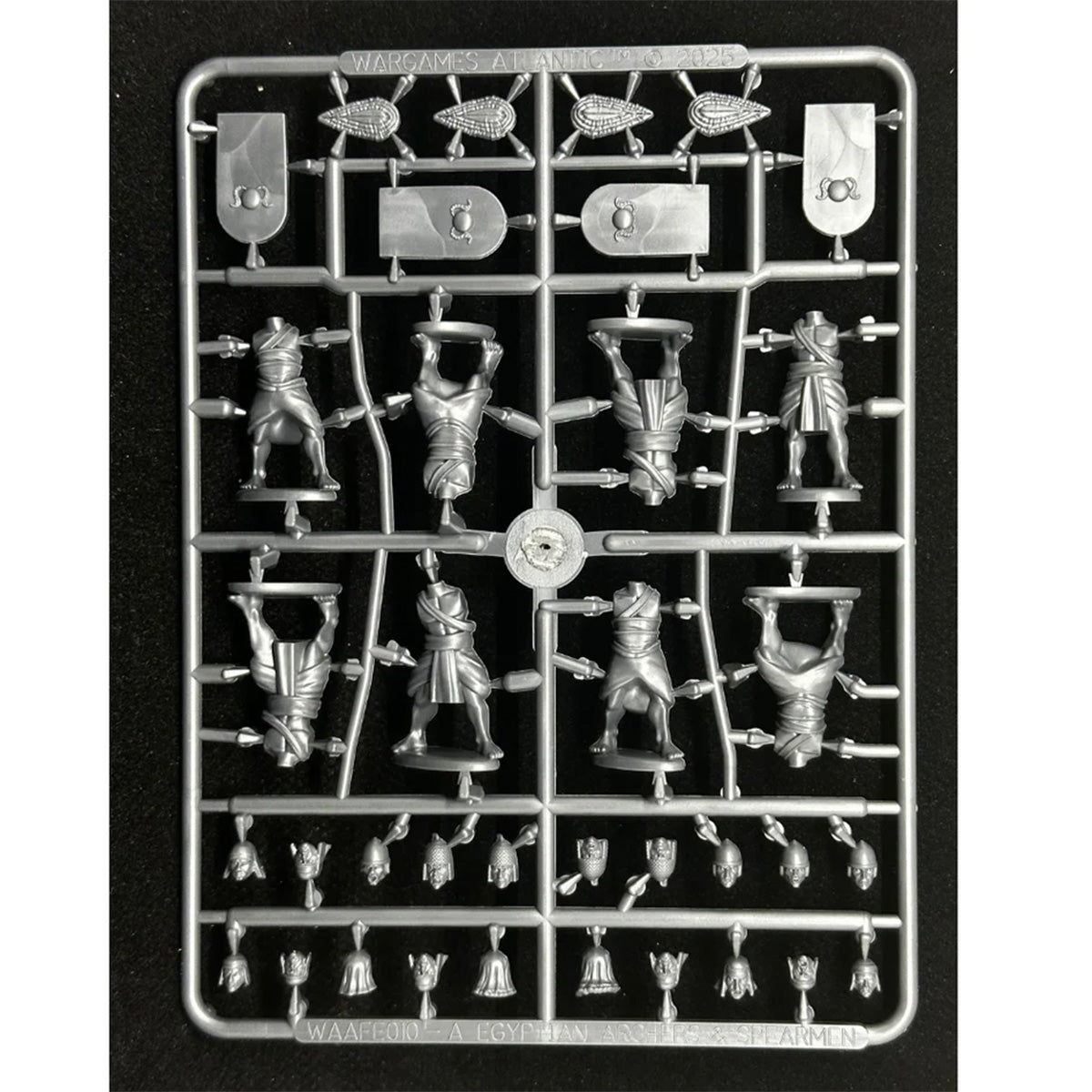 A grey, unpainted miniature figurine sprue (front) of Egyptian Archers and Spearmen, by Wargames Atlantic.  