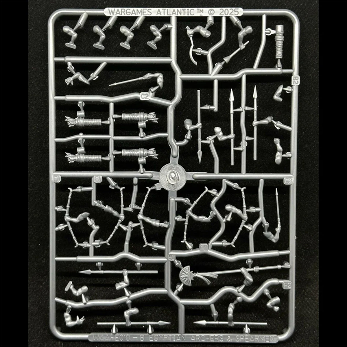 A grey, unpainted miniature figurine sprue of Egyptian Archers and Spearmen weapons, by Wargames Atlantic.  