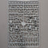 A gray plastic sprue containing unpainted Roman miniature figurines and accessories, photographed flat against a neutral gray background.