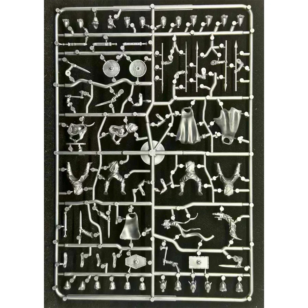 A plastic sprue containing various unpainted Dark Age Horse rider miniature figurines and accessories for model building, photographed against a solid black background.