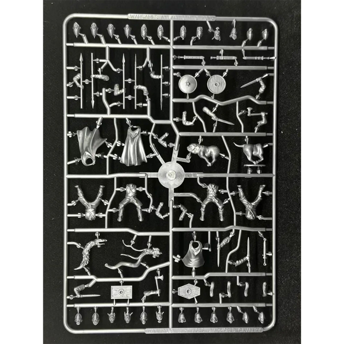 A plastic sprue containing various unpainted Dark Age Mounted figures, weapons, and accessories, photographed against a solid black background.