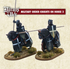 Two metal figures of medieval knights on horseback, painted in black armor with decorative elements, mounted on barded horses with shields and lances.